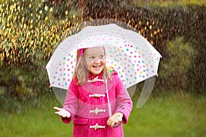 Little girl with umbrella in the rain