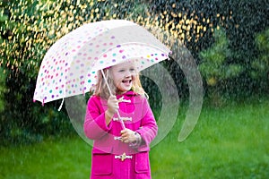 Little girl with umbrella in the rain