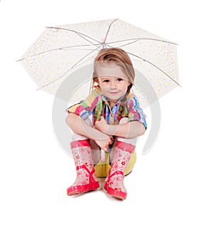 The little girl with an umbrella and in rubber