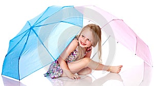 Little girl under an umbrella.