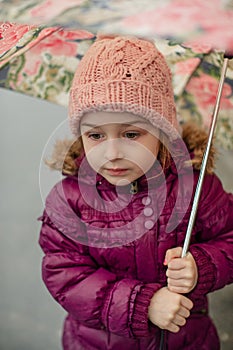 Little girl under the umbrella outside, rainy day. Little girl walks with umbrella under the rain