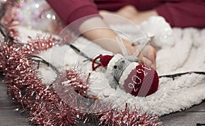 A little girl unpacks a box with Christmas decorations. New Year`s decorations. Christmas mood.