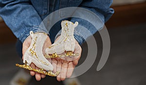 A little girl unpacks a box with Christmas decorations. New Year`s decorations. Christmas mood.