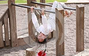 Little girl upside down at playground