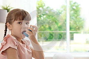 Little girl using asthma inhaler