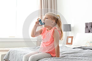 Little girl using asthma inhaler