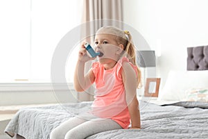 Little girl using asthma inhaler