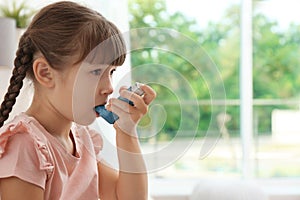 Little girl using asthma inhaler