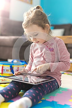 Little girl is using a digital tablet