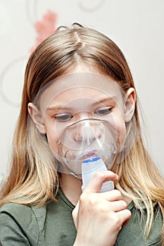 Little girl using an inhaler