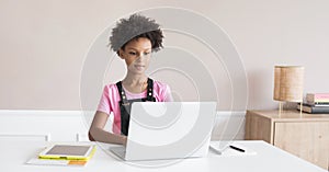 Little girl using laptop at home, child working online on computer indoor, Children lifestyle, distance education concept