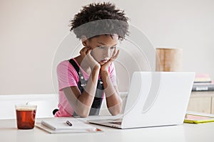 Little girl using laptop at home, child working online on computer indoor, Children lifestyledistance education, studying at home