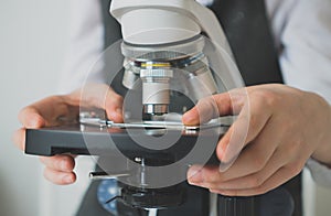 Little girl using microscope.