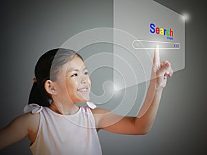 A little girl is using the Search virtual screen to searching for information. Online Search website for finding data on the
