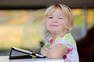 Little girl using tablet pc at home