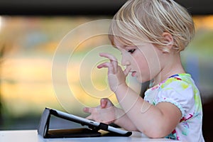 Little girl using tablet pc at home