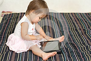 Little girl using a Tablet PC indoor