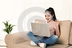 Little girl using video chat on laptop