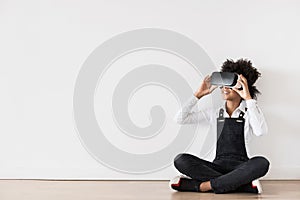 Little girl using virtual reality headset sitting on the floor panoramic banner, VR, future, gadgets, technology concept