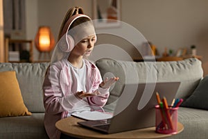 Little Girl Video Calling Learning Online Talking To Laptop Indoors