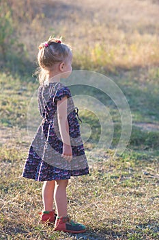 Little girl in vintage dress outdoors
