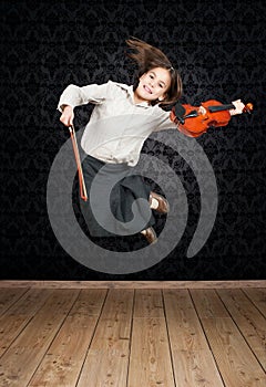 Little girl with violin jumping