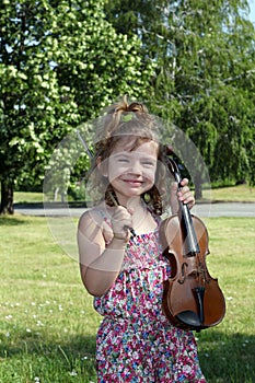 Little girl with violin in park