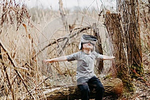 Little girl in virtual reality glasses outdoor