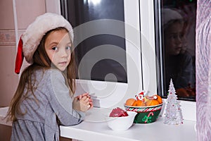 Little girl waiting Santa Claus magic Christmas window winter dark tangerine tale