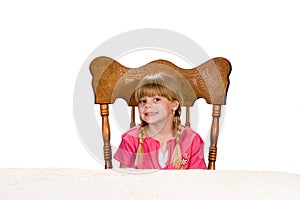 Little girl waiting at table