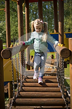 Little girl walk on outdoor slide