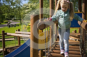 Little girl walk on outdoor slide