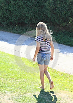 Little girl walking barefoot