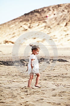 Little girl walking on beach