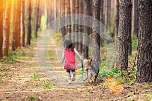 Little girl walking with big dog
