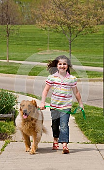 Little Girl Walking Dog