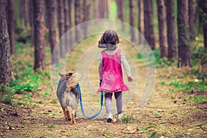 Little girl walking with dog