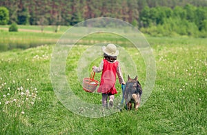 Little girl walking with dog