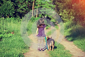 Little girl walking with dog