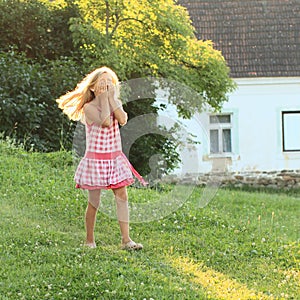 Little girl walking on meadow