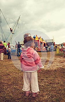 Little girl walking in a park, looks for her mum