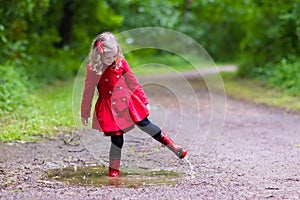 Little girl walking in the rain