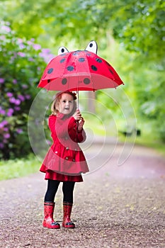 Little girl walking in the rain