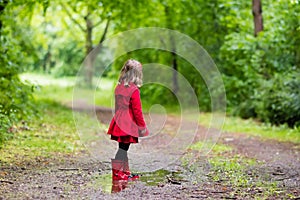 Little girl walking in the rain