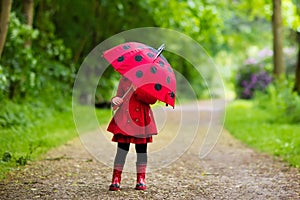 Little girl walking in the rain