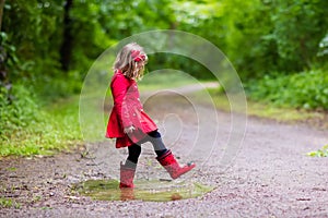 Little girl walking in the rain