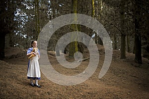 Little girl walking with wonder in forest