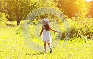 Little girl walks on nature