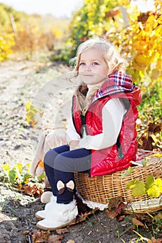 Little girl in warm clothes with toy rabbit