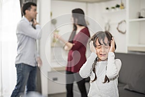 Little girl was crying because dad and mom quarrel, Sad and dramatic scene, Family issued, Children`s Rights abused in Early